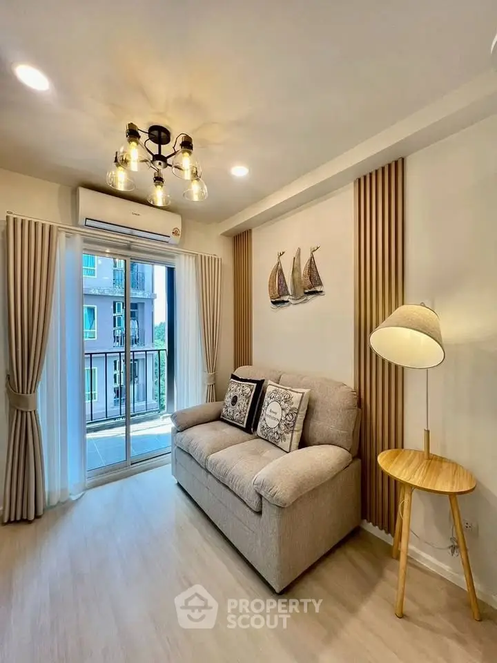 Charming living room with cozy sofa, stylish decor, and balcony view in modern apartment.