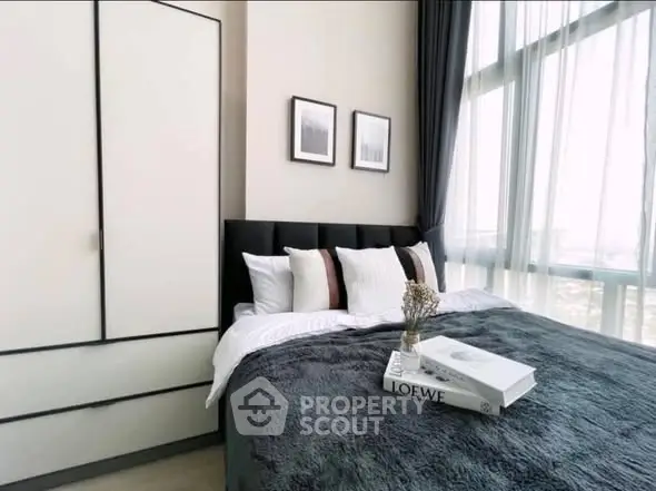 Modern bedroom with large windows and stylish decor