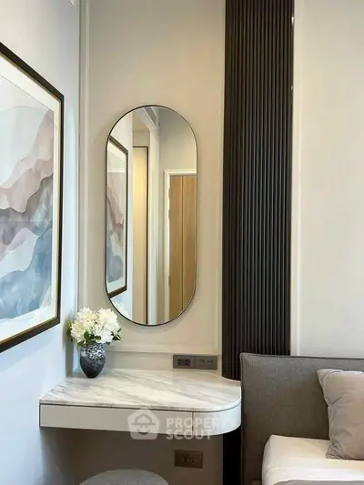 Elegant modern interior with stylish decor and mirror in a cozy living space.