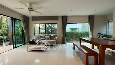 Spacious living room with garden view and modern furnishings