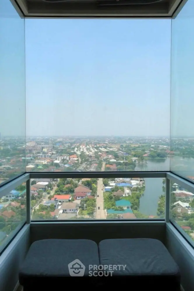 Stunning panoramic view from a high-rise balcony overlooking the cityscape and river.