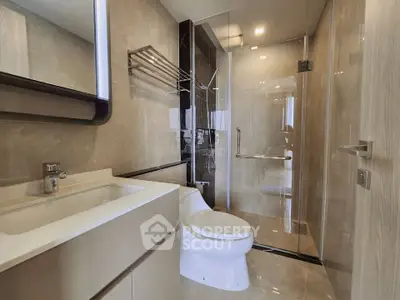 Modern bathroom with sleek fixtures and glass shower enclosure