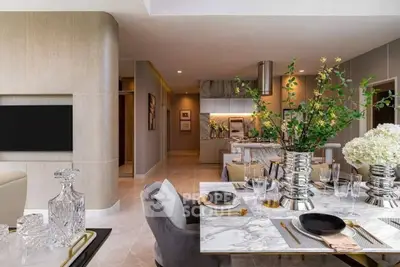 Luxurious open-plan living and dining area with elegant decor and modern kitchen.