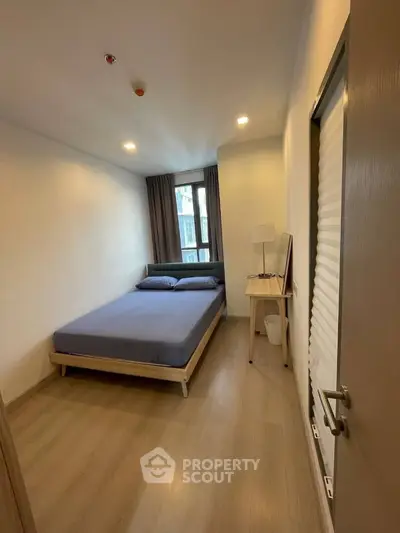 Cozy bedroom with modern decor and natural light, perfect for restful nights.