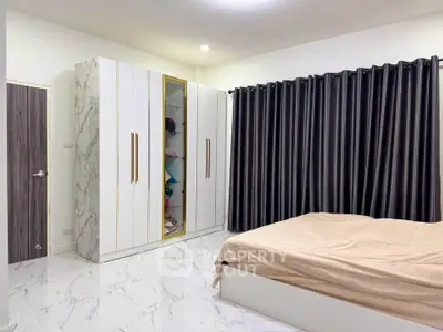 Spacious bedroom with modern wardrobe and elegant curtains