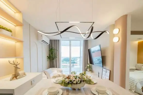 Modern living room with elegant lighting and stylish decor, featuring a large window with a scenic view.