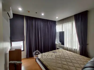 Modern bedroom with large windows and stylish curtains in a high-rise apartment.