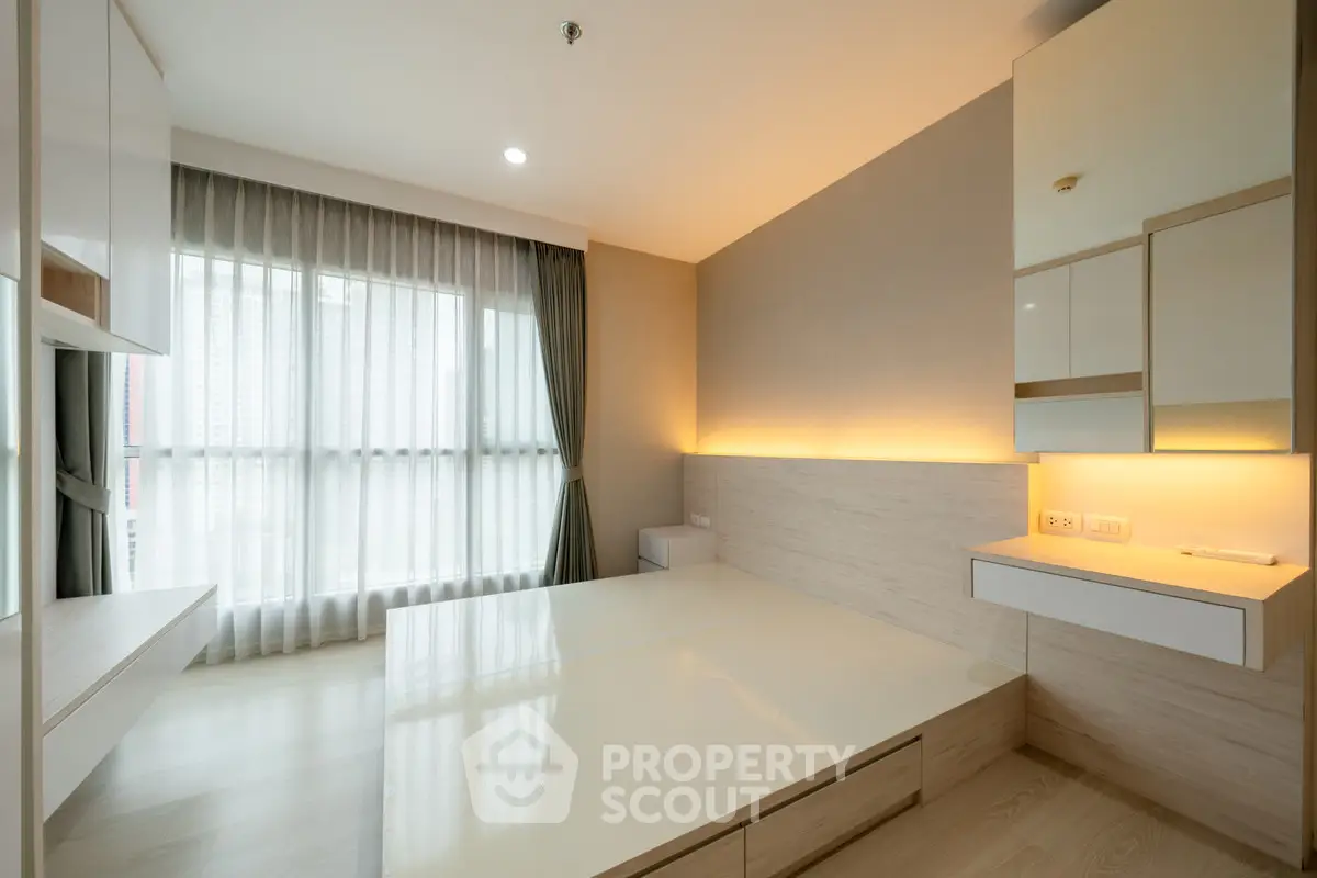 Modern minimalist bedroom with large window and built-in storage