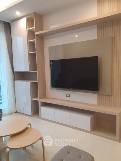 Modern living room with sleek TV unit and stylish furniture, perfect for contemporary urban living.