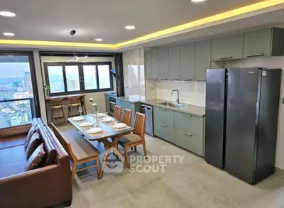 Modern open-layout kitchen and living area with city view, sleek appliances, and stylish dining setup.