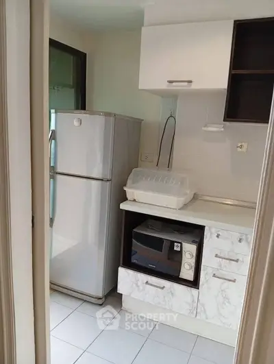 Compact kitchen with modern appliances and ample storage space