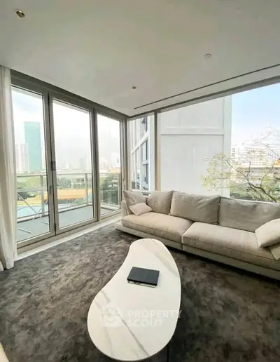 Luxurious corner unit living room with panoramic city views and elegant modern furnishings.