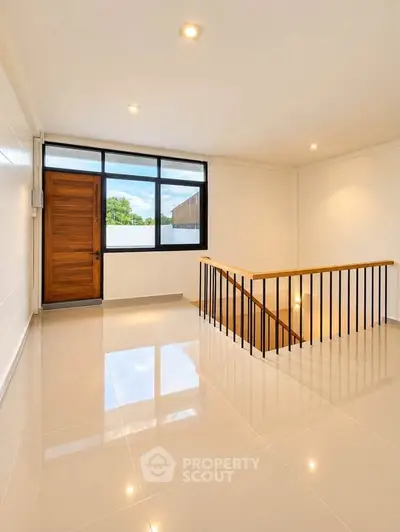 Spacious modern interior with glossy floors and wooden accents, perfect for stylish living.