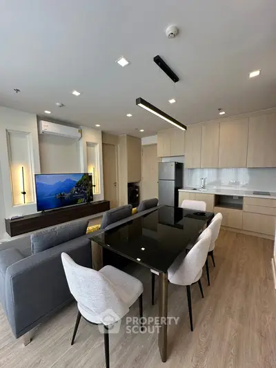 Modern open-plan living room with sleek kitchen and stylish dining area