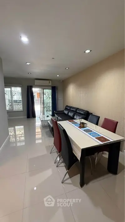 Spacious modern living room with sleek furniture and large windows for natural light.