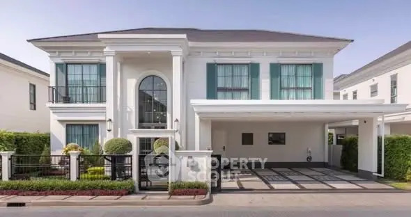Elegant two-story house with modern architecture and spacious driveway in a serene neighborhood.