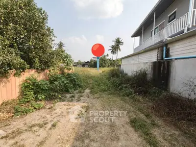 Spacious outdoor area with lush greenery and a modern building exterior, perfect for development opportunities.