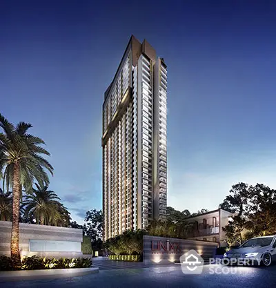 Luxurious high-rise building with modern architecture and elegant entrance at dusk.