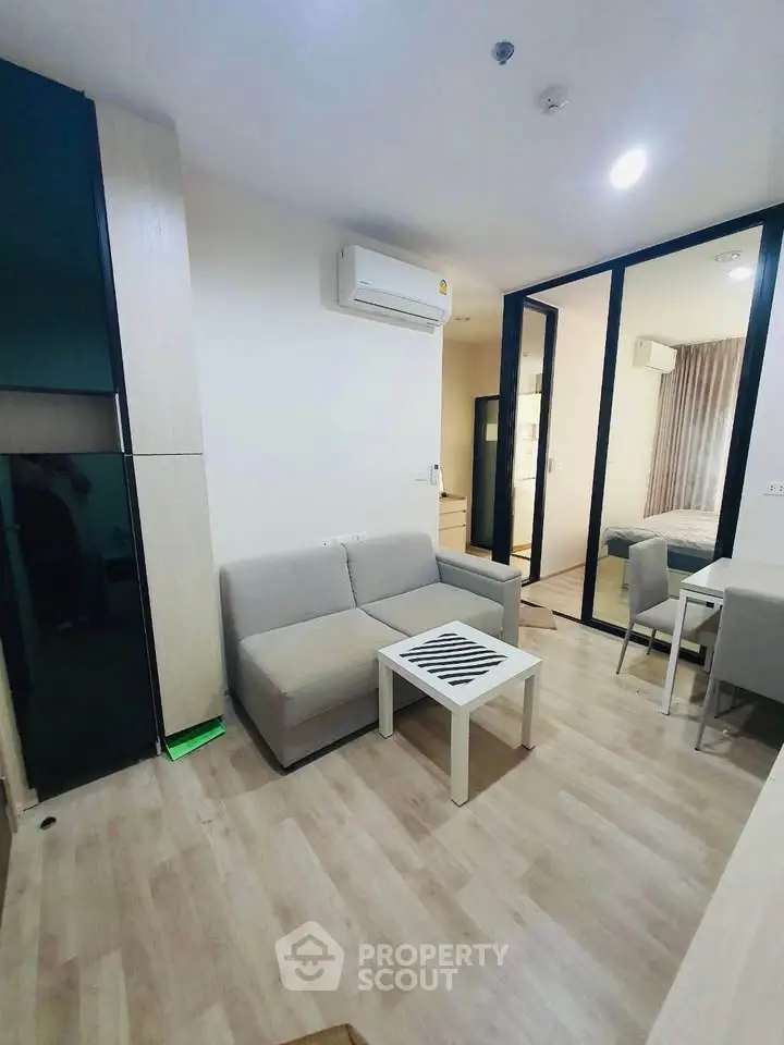 Modern living room with sleek furniture and air conditioning in a stylish apartment.