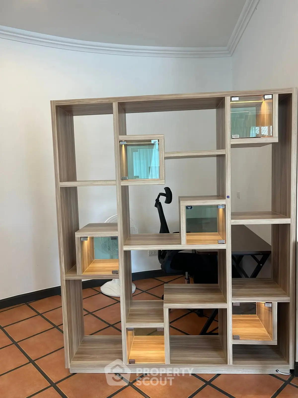 Modern study room with stylish wooden shelving and ergonomic office chair