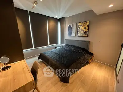Modern bedroom with stylish decor and ample natural light