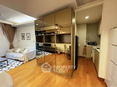 Modern living room with mirrored wardrobe and cozy seating area