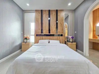 Modern bedroom with stylish wooden headboard and elegant decor