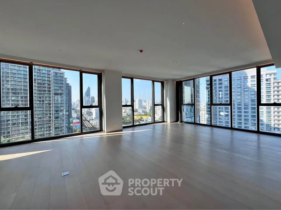 Spacious corner unit with panoramic city views and floor-to-ceiling windows.