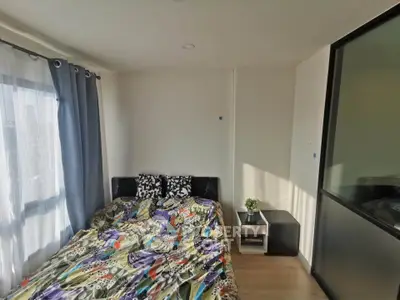 Cozy bedroom with modern decor and ample natural light