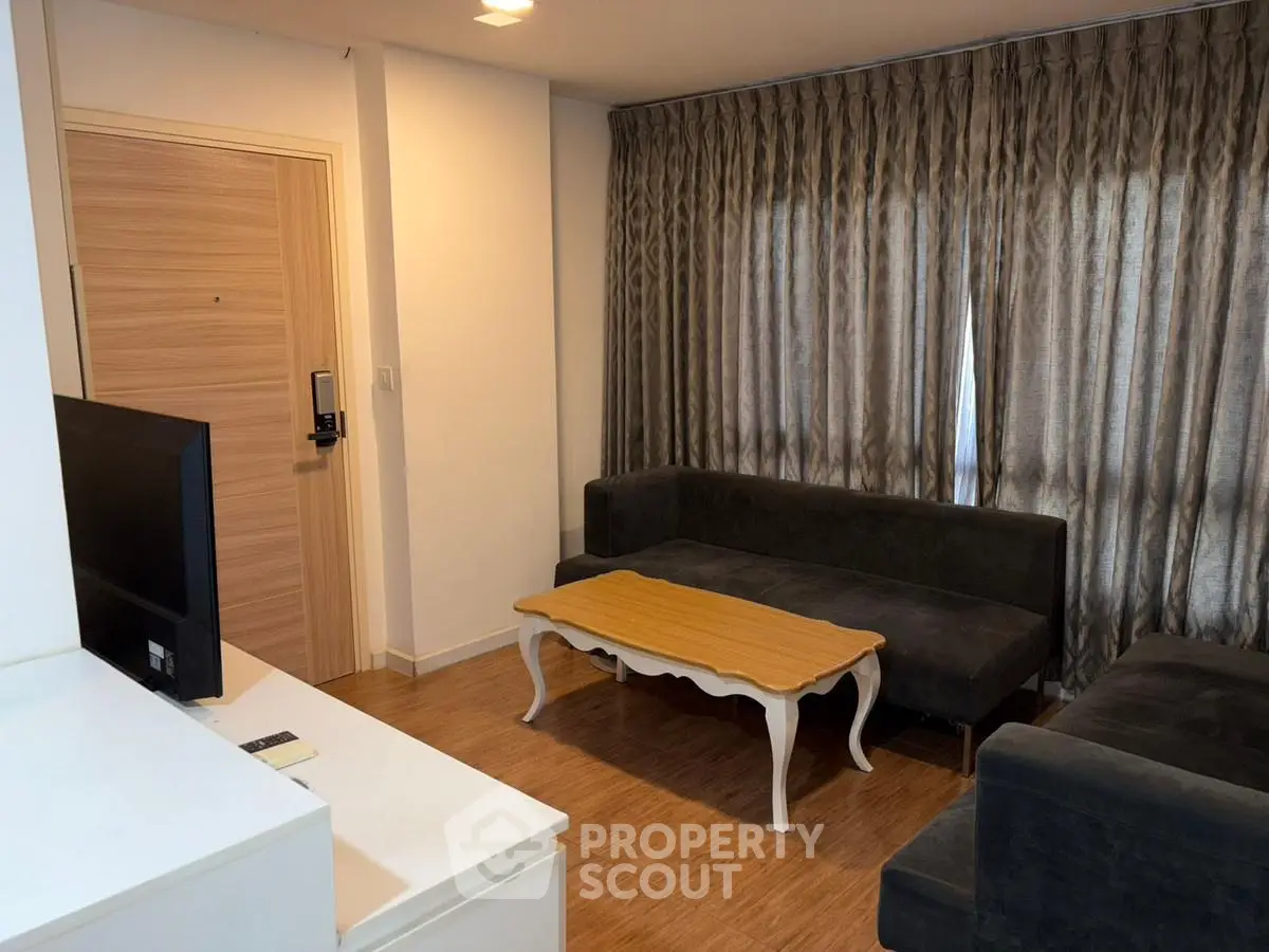 Cozy living room with elegant curtains and modern furniture, perfect for relaxation.