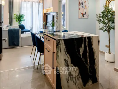Modern open kitchen with elegant marble island and stylish dining area