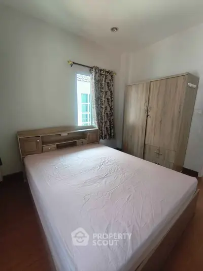 Cozy bedroom with wooden furniture and natural light