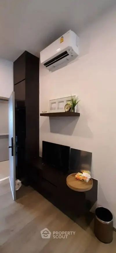 Modern living room with air conditioning and stylish shelving