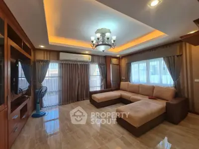 Spacious living room with elegant lighting and large sectional sofa in modern home.