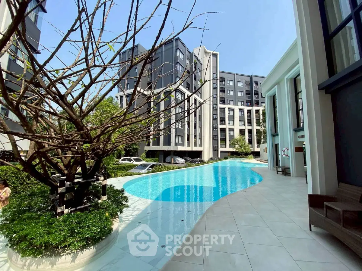 Luxurious modern apartment complex with stunning pool and lush greenery