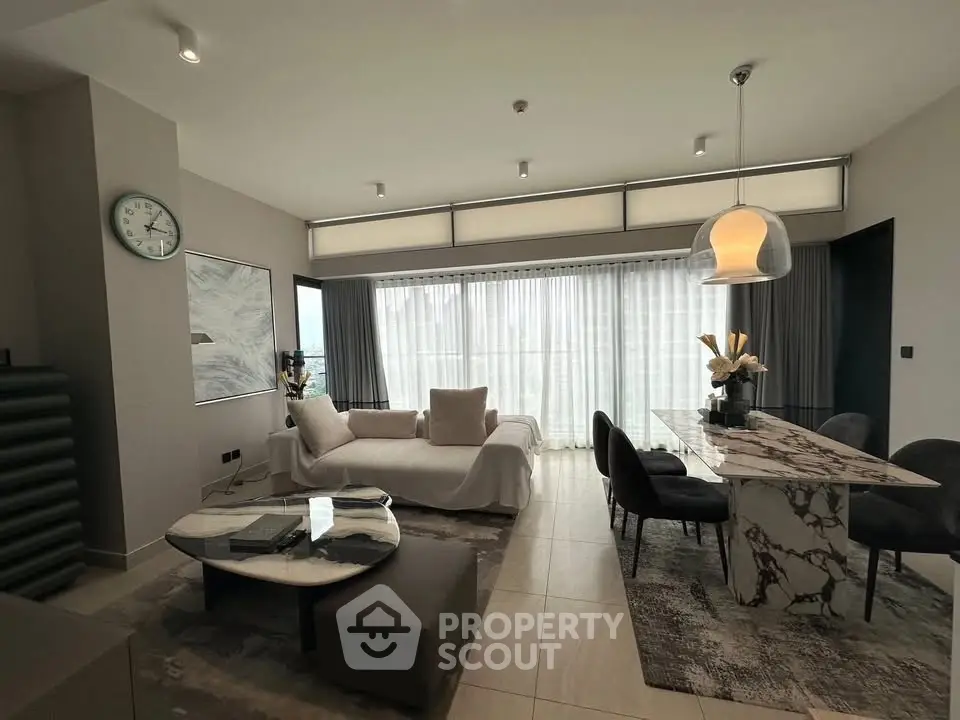 Luxurious modern living room with elegant marble dining table and cozy seating area, perfect for stylish urban living.