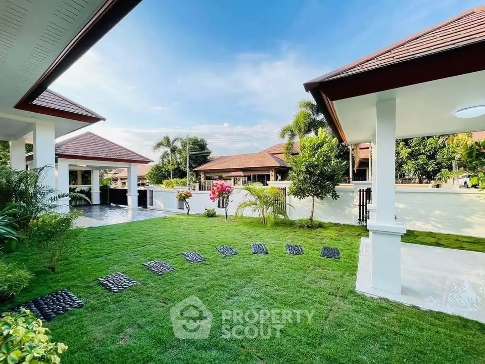 Beautiful garden view with lush greenery and modern architecture in a serene residential area.