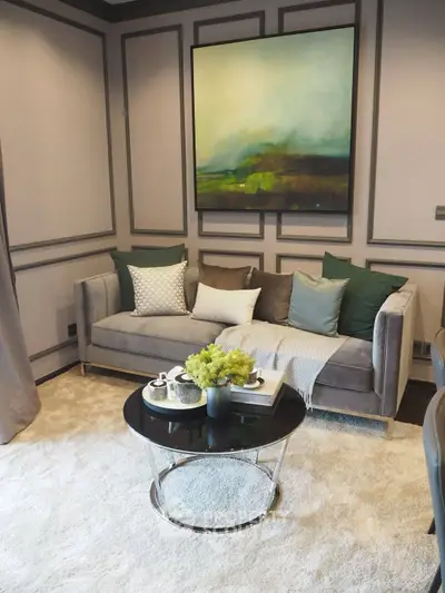 Elegant living room with plush sofa, modern art, and stylish decor