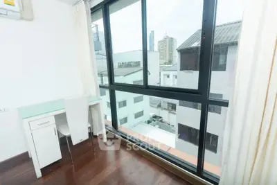 Bright study room with city view and modern desk setup