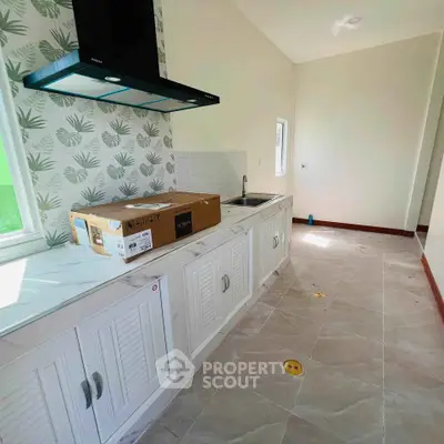 Modern kitchen with sleek cabinetry and stylish backsplash in a bright, airy space.