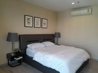 Modern bedroom with stylish decor and comfortable bedding in a cozy apartment.