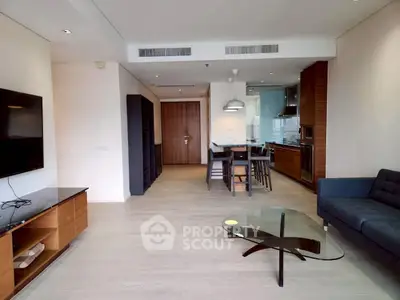 Spacious modern living room with open kitchen layout and stylish furnishings.