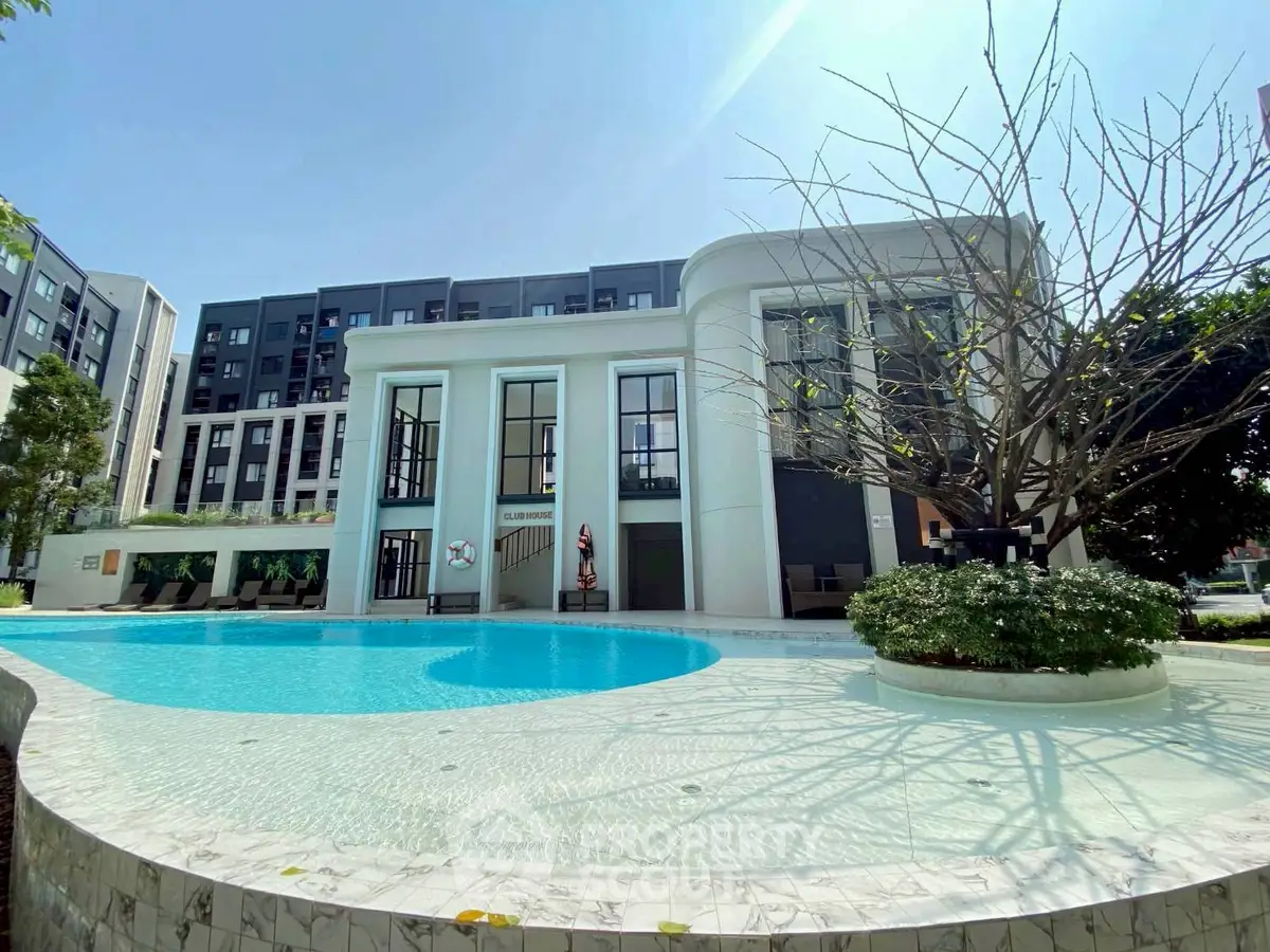Luxurious residential building with a stunning pool and modern architecture.