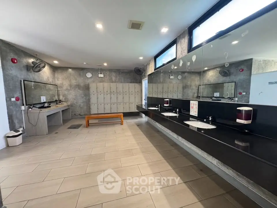 Spacious modern gym locker room with sleek design and ample storage.