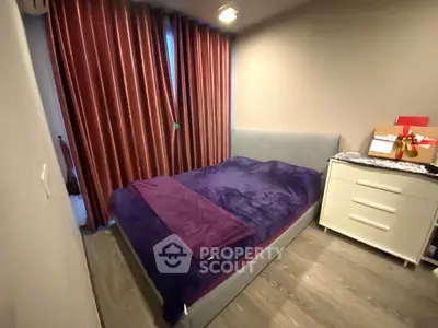 Cozy bedroom with modern decor and plush bedding in a stylish apartment.