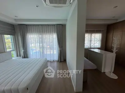 Spacious bedroom with natural light and modern decor