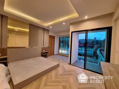 Luxurious modern bedroom with large glass doors and scenic balcony view.