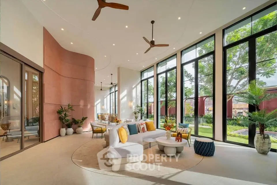 Luxurious modern living room with floor-to-ceiling windows and garden view