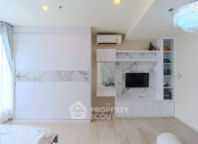 Modern living room with sleek white cabinetry and built-in TV unit