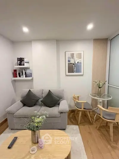 Cozy living room with modern decor and comfortable seating in a stylish apartment.
